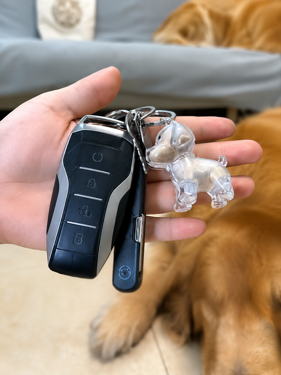 Dog-shaped EternalPaw keychain attached to car keys in hand